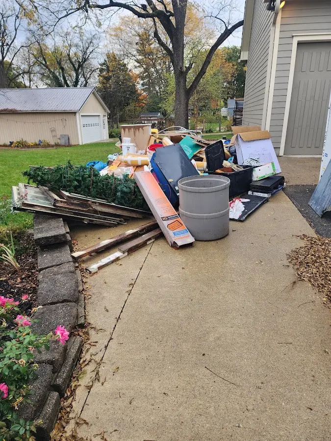 Dumpster being loaded with debris for Roofing Dumpster Rental in Fruit Hill